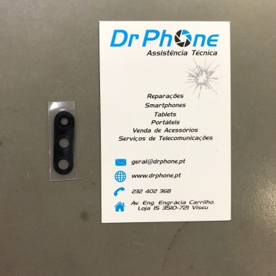Peça pequena preta e cartão de visita da Dr Phone Assistência Técnica sobre superfície cinzenta