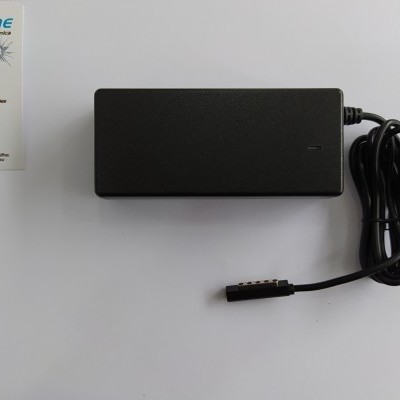 Carregador portátil preto com cabo enrolado junto a cartão de visita da Dr Phone