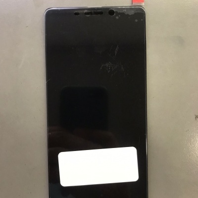 Ecrã de telefone móvel preto com etiquetas aplicada numa superfície cinzenta