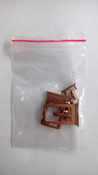 Saco plástico transparente com peças pequenas castanhas dentro