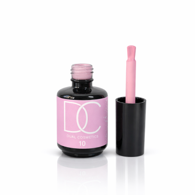 Frasco aberto de verniz de unhas rosa claro com tampa preta e pincel ao lado