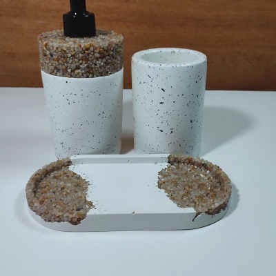 Conjunto branco de acessórios de casa-de-banho com pedras decorativas pequenas