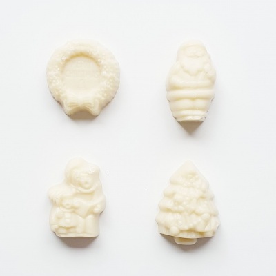 quatro sabonetes brancos com formas natalícias em fundo branco