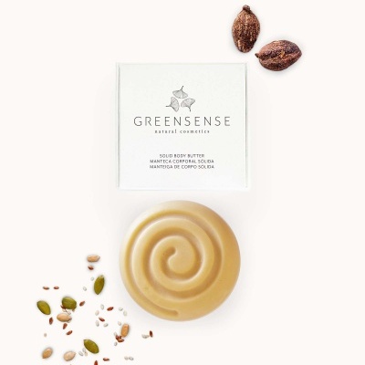 Manteiga corporal sólida GREENSENSE com embalagem branca e sementes ao lado