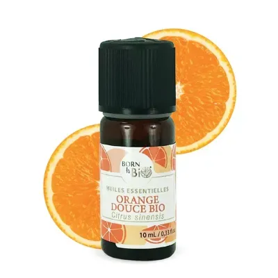 Frasco de óleo essencial de laranja doce com duas metades de laranja ao fundo