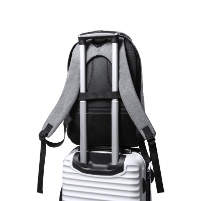 Mochila cinzenta e preta presa a mala de viagem branca com pega telescópica