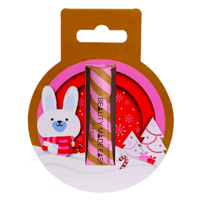 Bálsamo labial rosa e dourado em suporte decorado com coelho e decoração de Natal