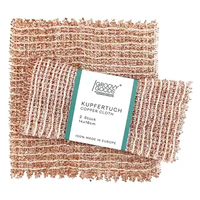 Dois panos de cobre texturizados com etiqueta central sobre fundo branco.
