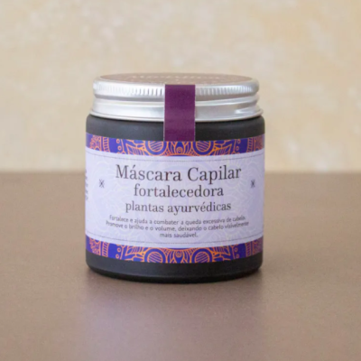 Frasco de máscara capilar fortalecedora com rótulo branco e detalhes roxos