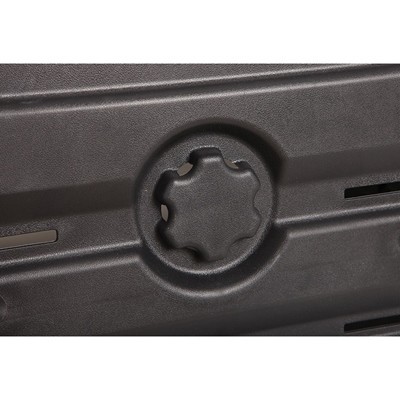 Botão ou roda de plástico preto texturizado num painel preto