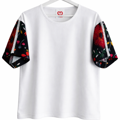 T-shirt branca com mangas florais e detalhes de renda branca suspensa num cabide.