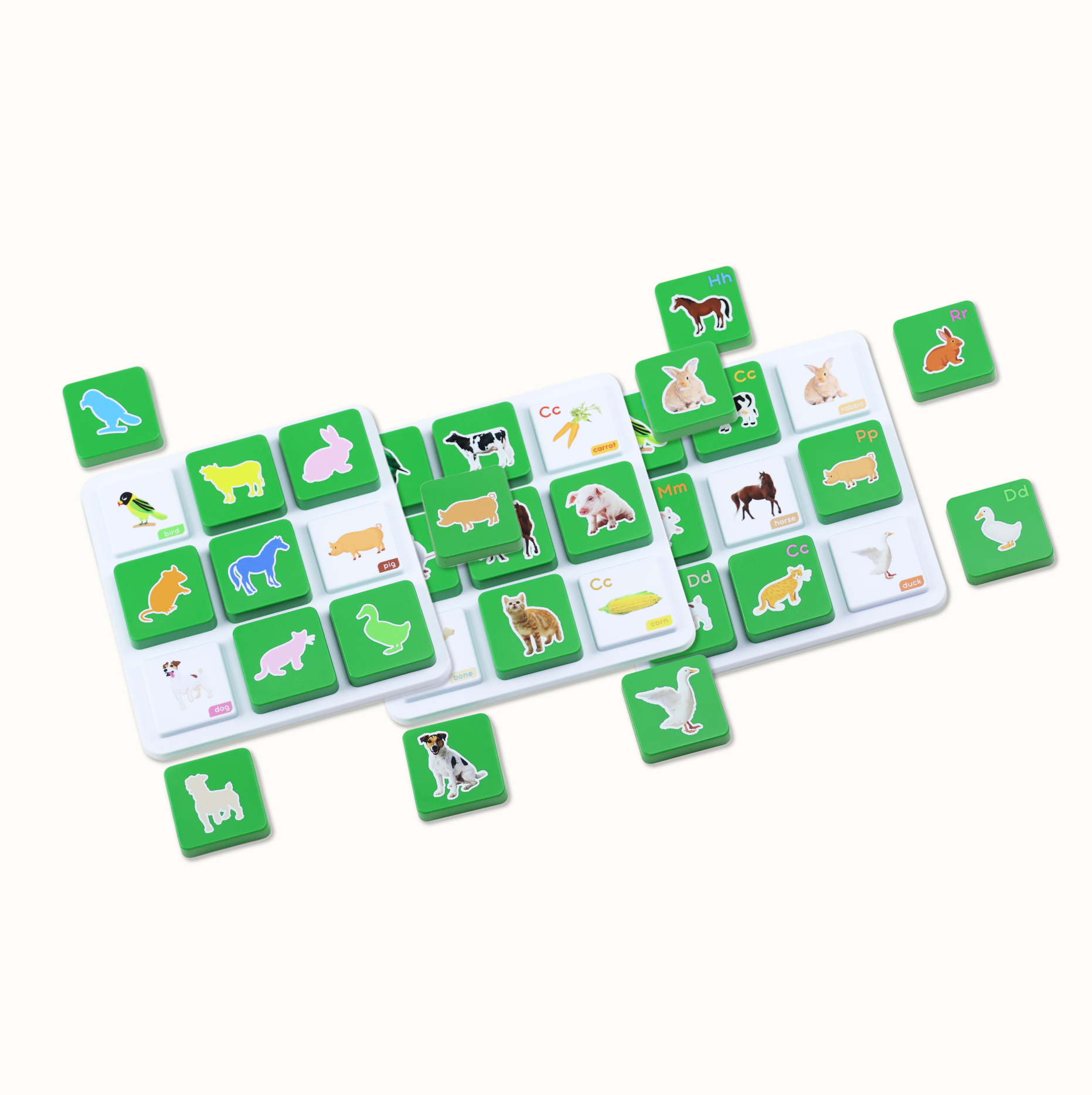 Educational animal and letter toy tiles scattered on a white surface.