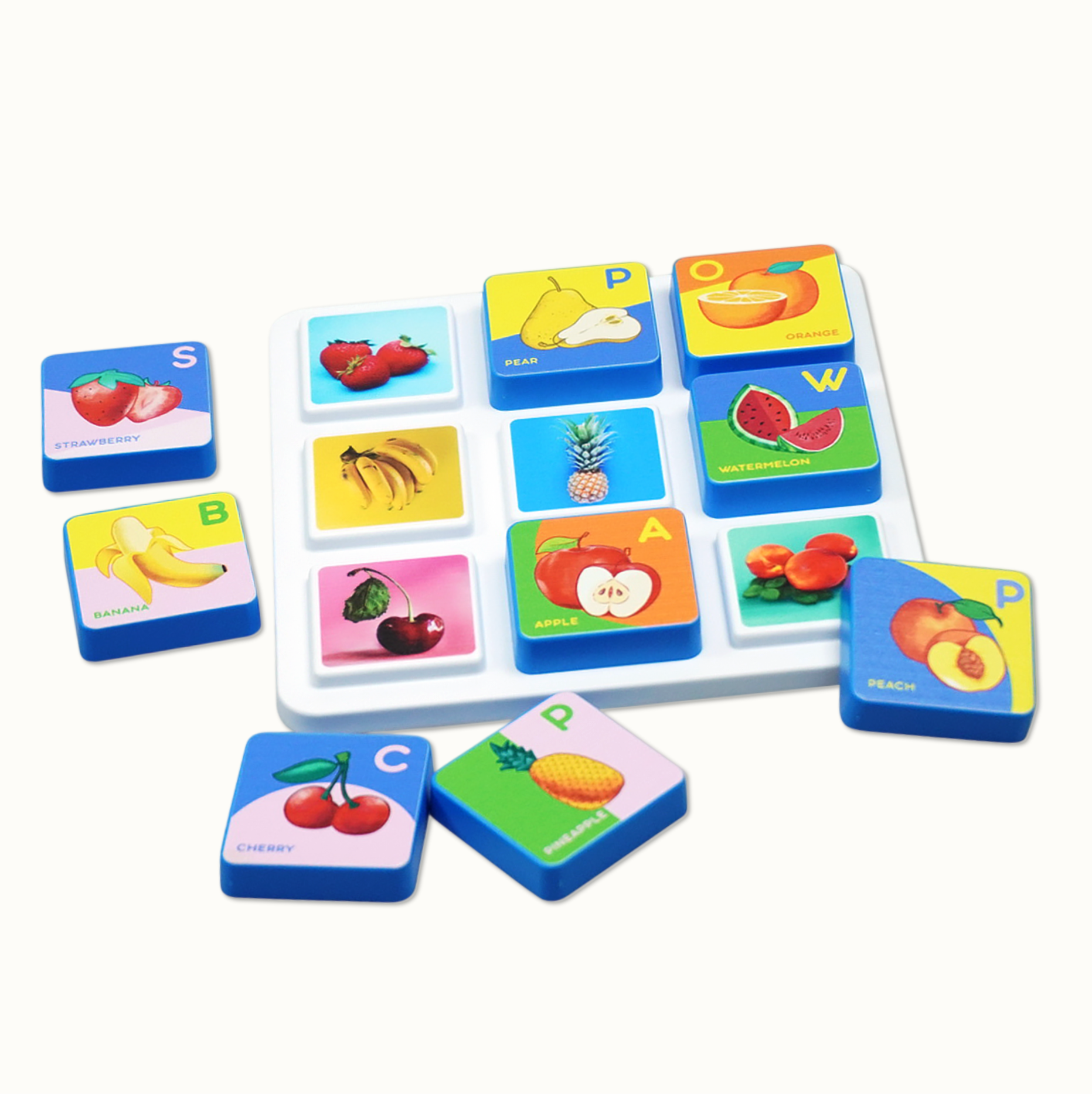 Educational fruit blocks with letters and names on white tray