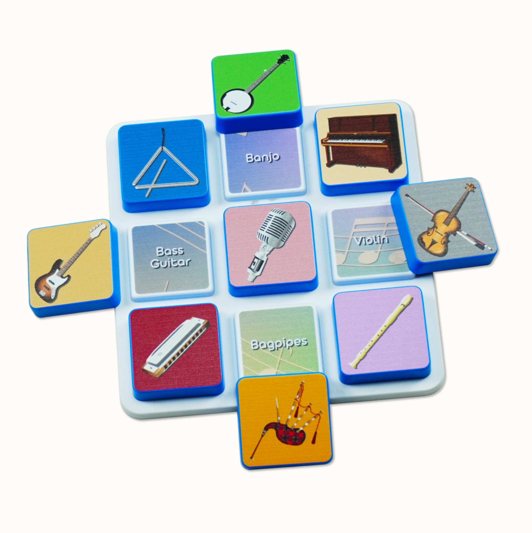 Square magnetic tiles with musical instrument images and labels on a white plastic base