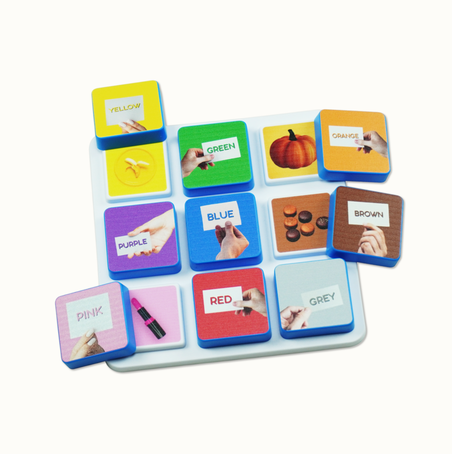 Educational game tiles with color names and matching images on a white tray
