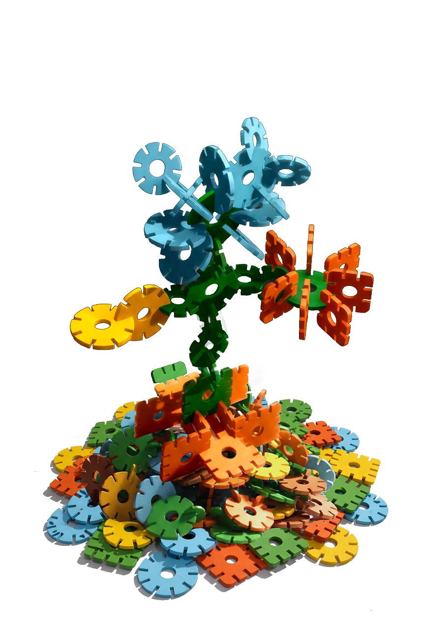 Klick - Starter Pack Colorful plastic gear and flower-shaped interlocking construction toy pieces assembled and scattered on white background
