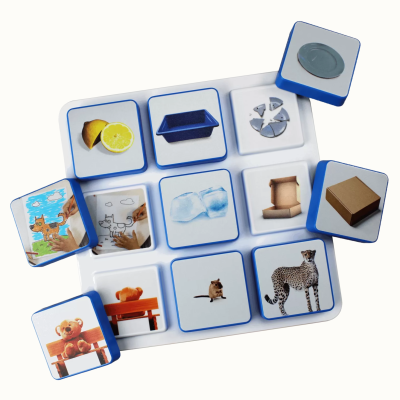 Square tiles with various objects and animals images on a white tray