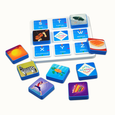 Educational game tiles with images and words on a white tray.