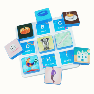 Educational game board with blue letter tiles and matching picture tiles in a white plastic frame.