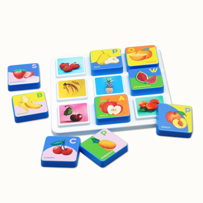 Educational fruit blocks with letters and names on white tray