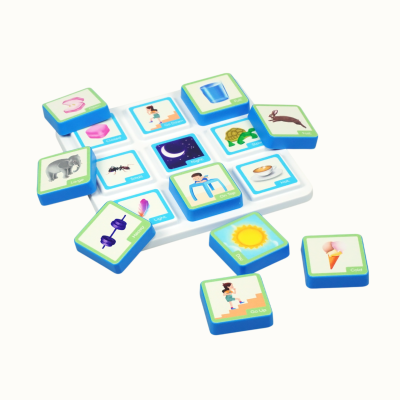 Childrens educational game set with blue tiles having images and words on a white board