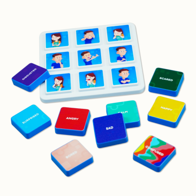 Colorful emotion word tiles and a white tray with cartoon faces showing emotions