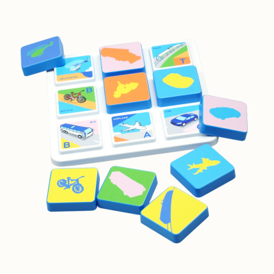 Childrens matching memory game with colorful vehicle tiles on white tray
