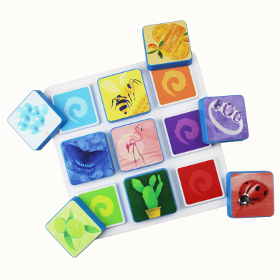 Colorful illustrated square tiles with animal and object designs on a white tray.