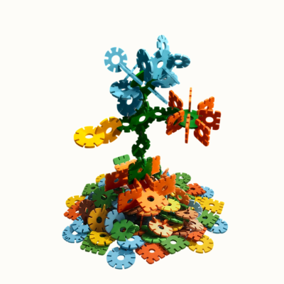 Colorful interlocking discs assembled into a flower with a pile of discs underneath