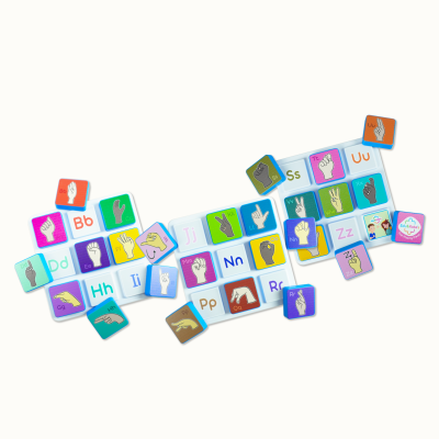 Educational ASL alphabet tiles with hand signs and letters on a white keyboard board.