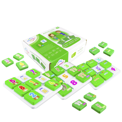 Educational activity kit with green and white number tiles and matching packaging on white background