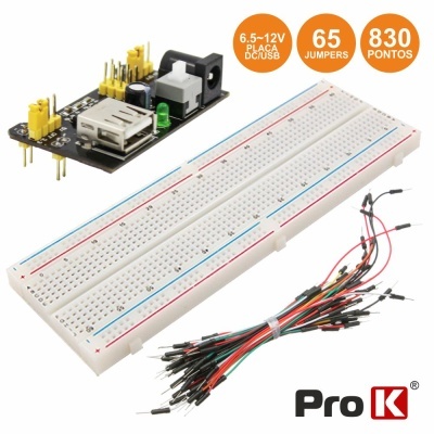Kit de prototipagem com breadboard, cabos jumper e placa adaptadora com texto informativo.