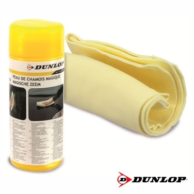 Frasco amarelo com etiqueta Dunlop e pano amarelo claro enrolado de pele de camurça