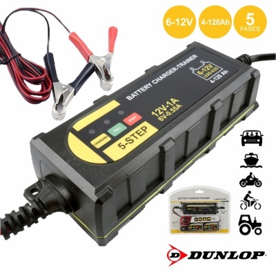 Carregador de baterias Dunlop preto com cabos e garras, texto em amarelo e verde, embalagem visível