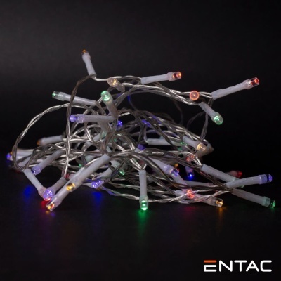 Cordão de luzes LED multicoloridas com fios brancos sobre fundo preto