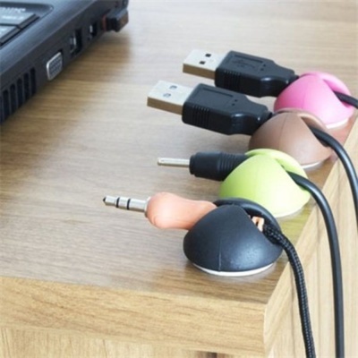 Cabos organizados com suportes coloridos na mesa de madeira junto a portátil