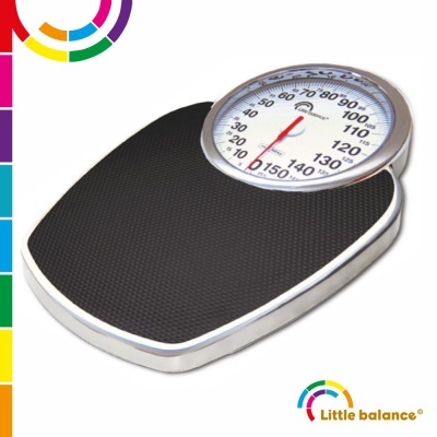 Balança mecânica preta com mostrador redondo e escala de peso