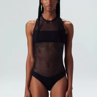 Mulher a usar body transparente de malha preta com padrão de rede