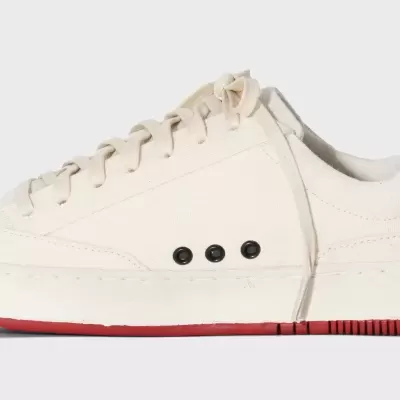 Ténis branco de couro com detalhe preto e sola vermelha