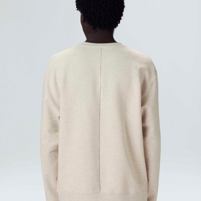 Suéter bege claro visto de costas com costura central visível