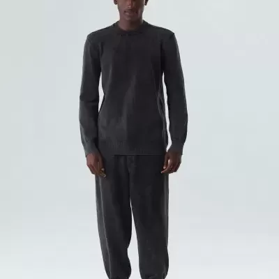 Conjunto de malha preta com camisola e calças, vista frontal.