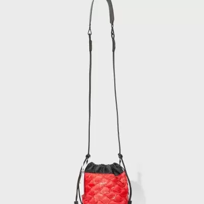 Mala pequena tipo saco vermelha e preta com textura acolchoada brilhante e alça longa preta