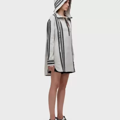 Tunica branca com riscas pretas e capuz, sapatos desportivos brancos e pretos