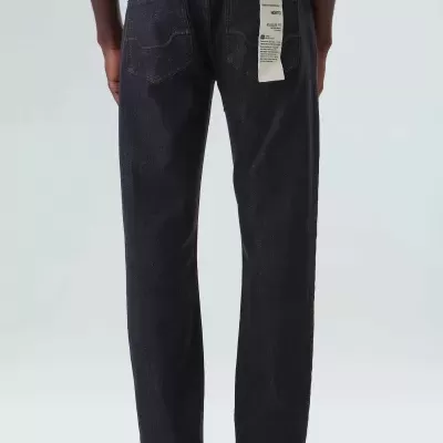 Calças de ganga castanhas escuras vistas de trás com etiqueta no bolso direito