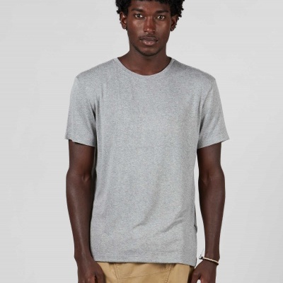 Homem a usar t-shirt cinza clara de manga curta e calças bege