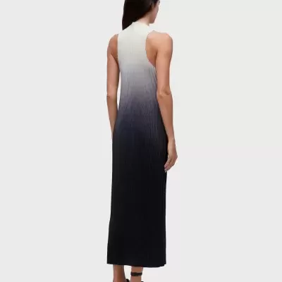 Vestido longo degradê branco para preto, tecido canelado, visto de costas por mulher com sandálias pretas