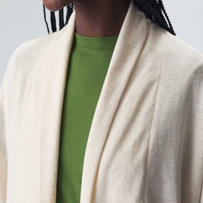 Pessoa com casaco de malha bege e t-shirt verde