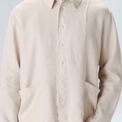 Camisa bege claro de manga comprida com botões e bolsos frontais
