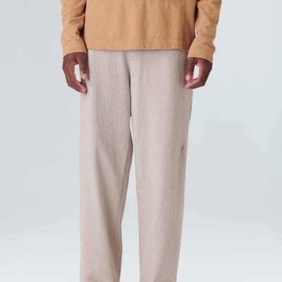 Calças compridas bege claro com camisa castanha clara e sapatos beges