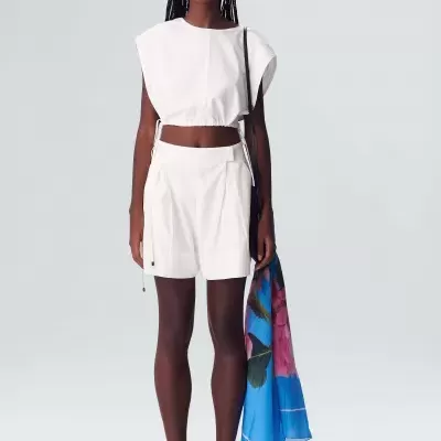 Conjunto feminino branco com lenço azul florido, óculos escuros e calçado branco